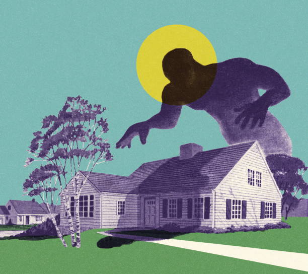 Personnage géant en silhouette penché au dessus d'une maison